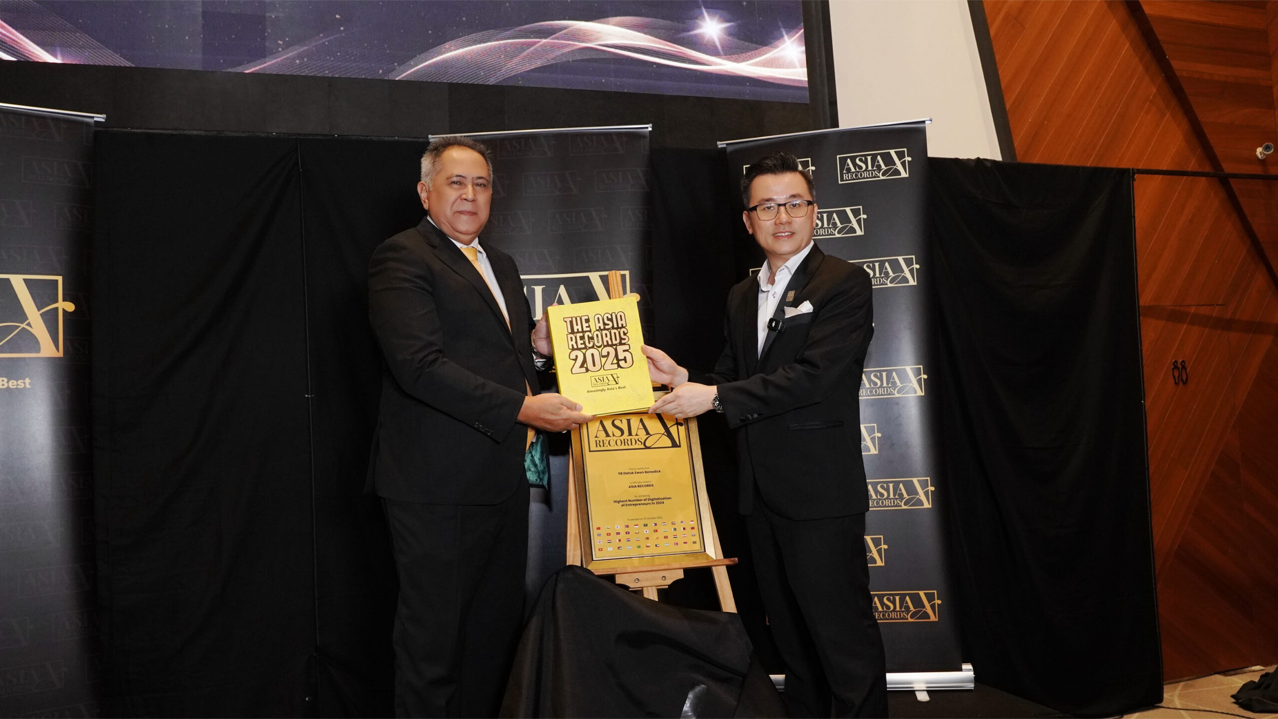 Advisor, Tunku Fauzi Tunku Abdul and Dato KK Chua on stage with The Asia Records cert and book on stage